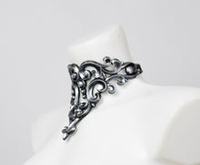 Load image into Gallery viewer, Side view of a choker necklace made from silver metallic latex to look like real metal.
